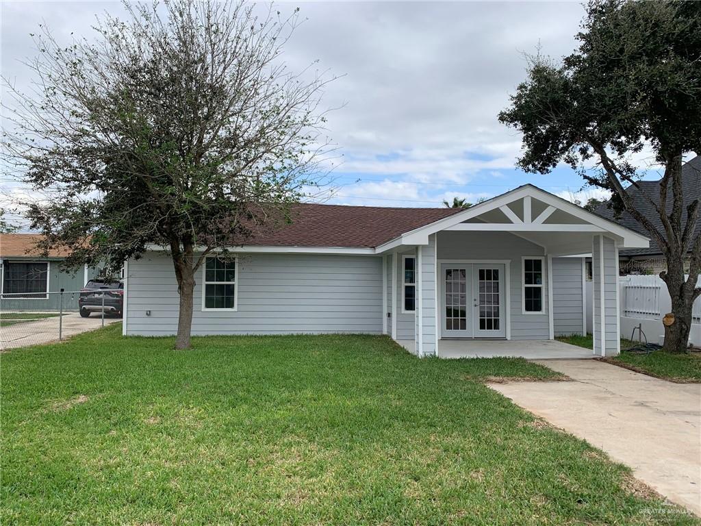 10824 Compadres Street Mercedes, TX 78570 - Photo 2 of 19 a front view of house with yard and trees