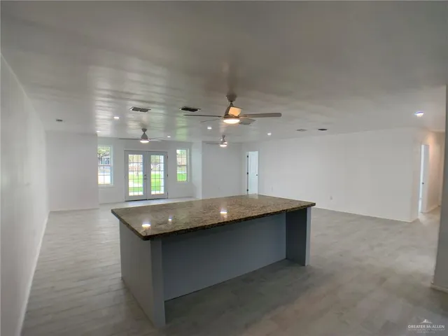 a living room with granite countertop furniture and a chandelier