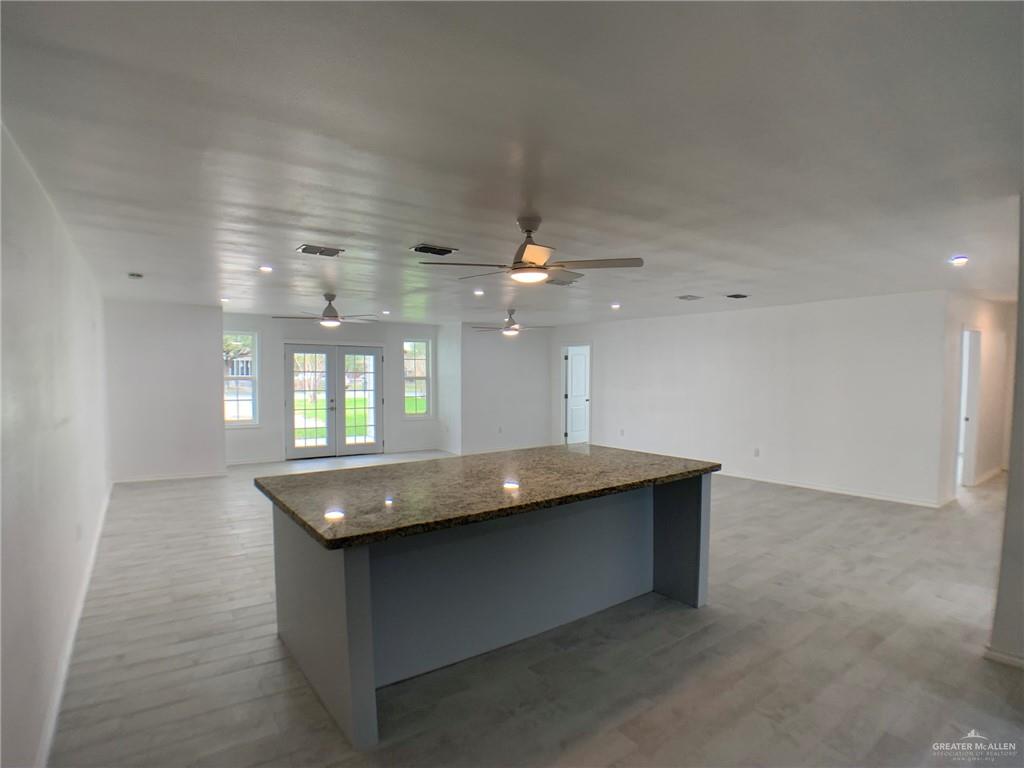 10824 Compadres Street Mercedes, TX 78570 - Photo 7 of 19 a living room with granite countertop furniture and a chandelier