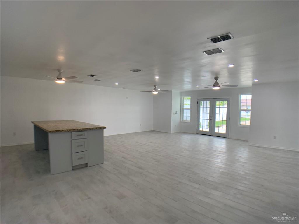 10824 Compadres Street Mercedes, TX 78570 - Photo 9 of 19 wooden floor in an empty room with a window