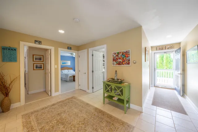 a living room with furniture and a open kitchen