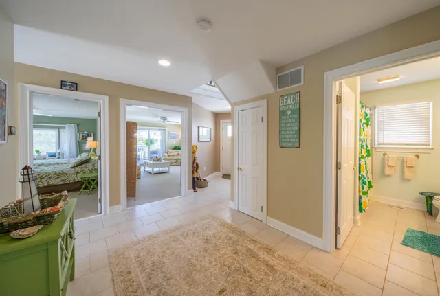 a view of a hallway with living room and dining room