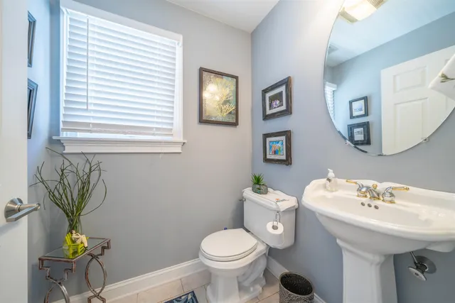 a bathroom with a sink mirror and toilet
