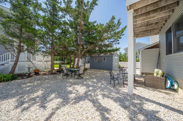a view of a house with backyard and sitting area