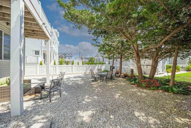 a view of a house with backyard porch and sitting area