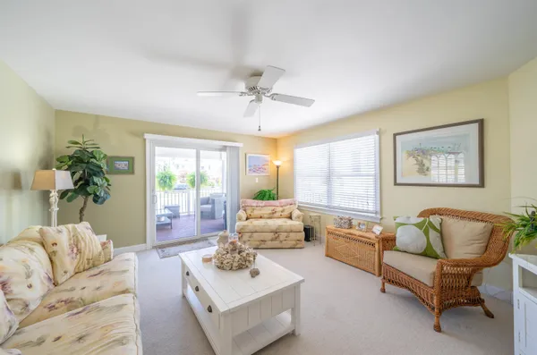a view of a hallway with living room and dining room