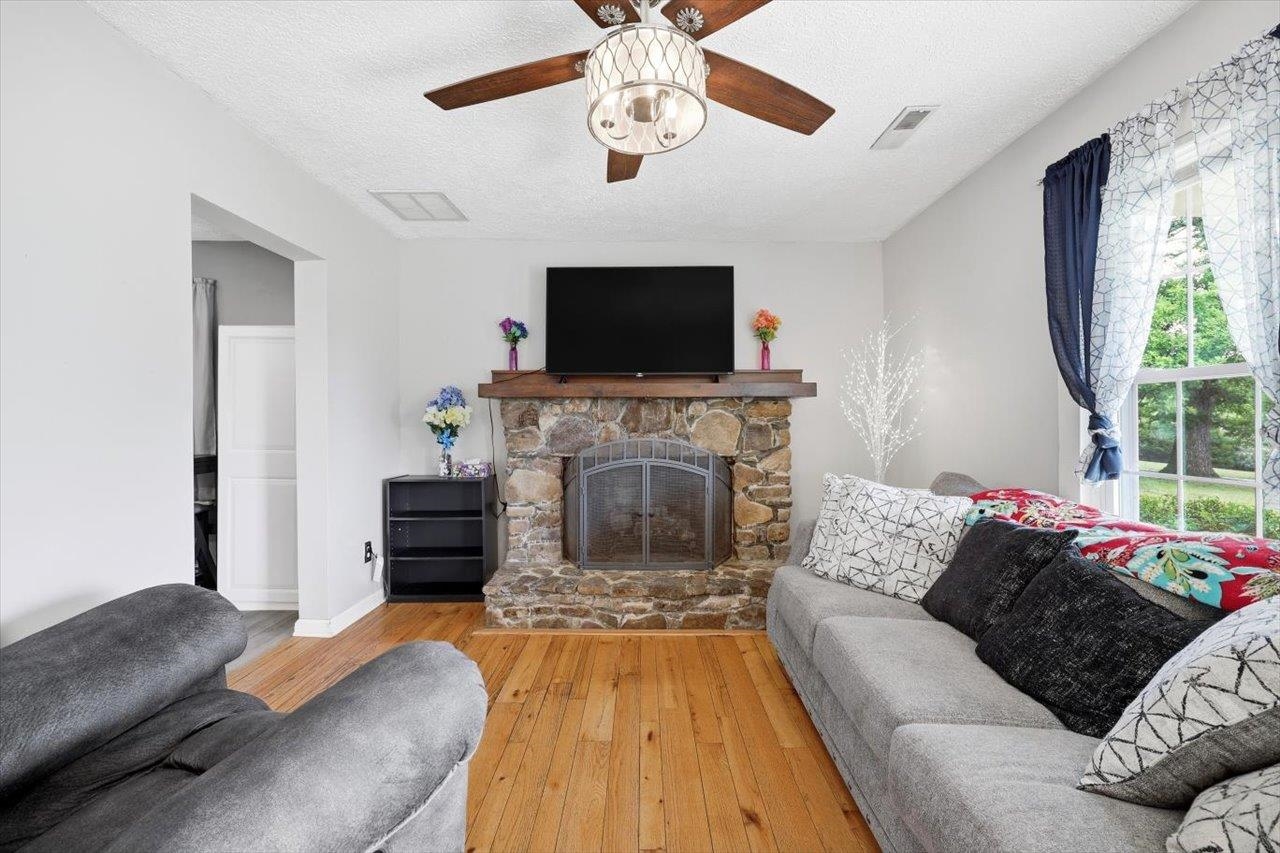 1296 New Hope Road Staunton, VA 24401 - Photo 4 of 37 a living room with furniture a flat screen tv and a fireplace