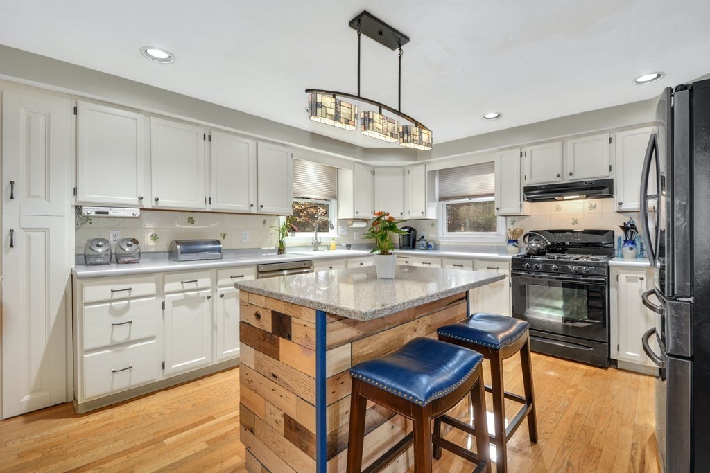 16 Barrett Road Marlborough, MA 01752 - Photo 18 of 41 a kitchen with a stove cabinets and a refrigerator