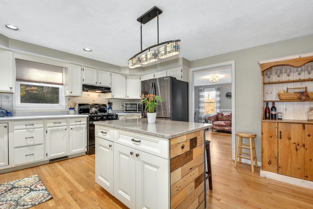 16 Barrett Road Marlborough, MA 01752 - Photo 19 of 41 a kitchen with stainless steel appliances kitchen island granite countertop a sink cabinets and wooden floor