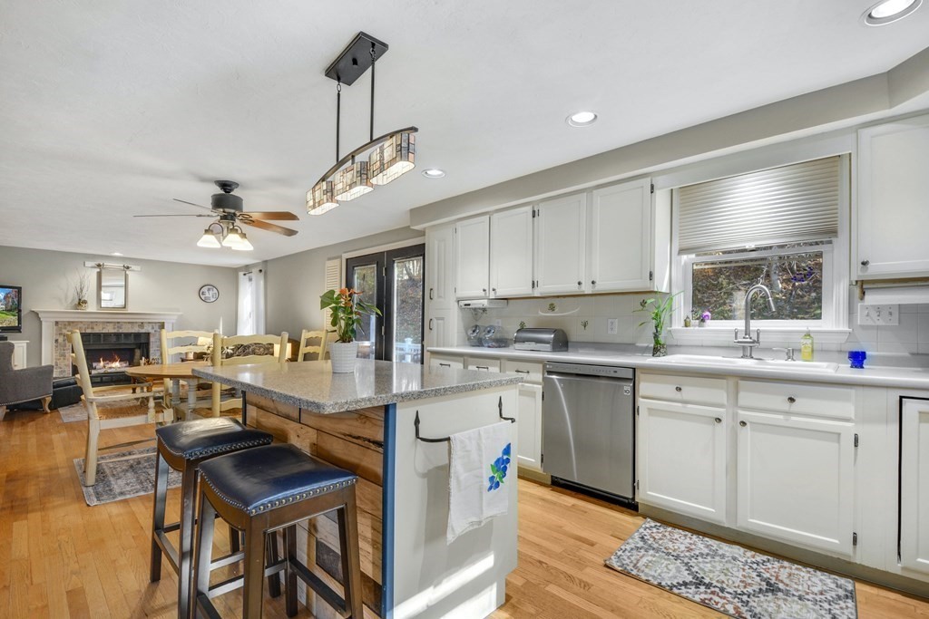 16 Barrett Road Marlborough, MA 01752 - Photo 21 of 41 a open kitchen with stainless steel appliances granite countertop a stove top oven a sink a dining table and chairs with wooden floor