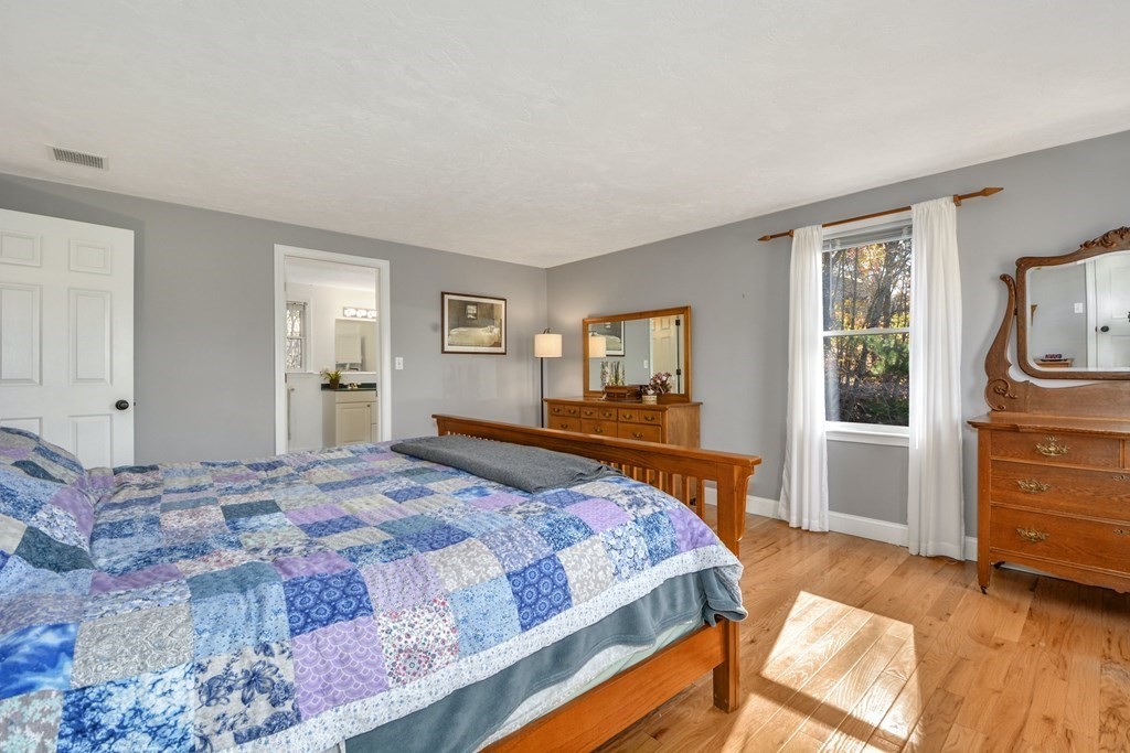 16 Barrett Road Marlborough, MA 01752 - Photo 27 of 41 a bedroom with a bed and wooden floor