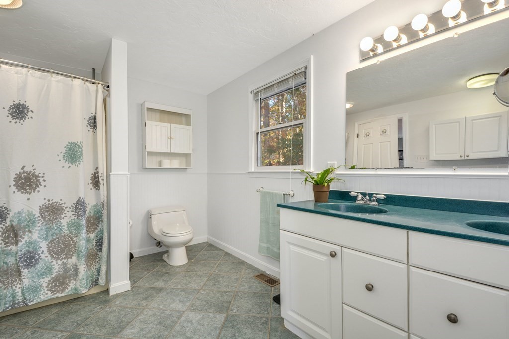 16 Barrett Road Marlborough, MA 01752 - Photo 29 of 41 a bathroom with a granite countertop sink a toilet and a mirror