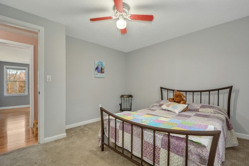 16 Barrett Road Marlborough, MA 01752 - Photo 33 of 41 a bedroom with a bed and a chandelier