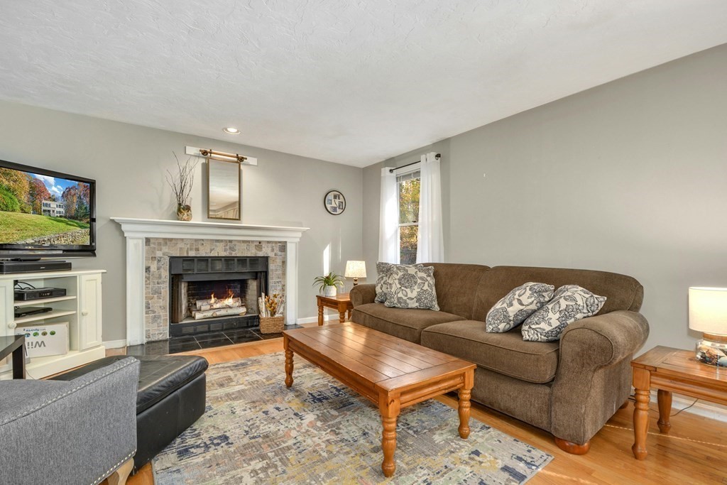 16 Barrett Road Marlborough, MA 01752 - Photo 9 of 41 a living room with furniture and a fireplace