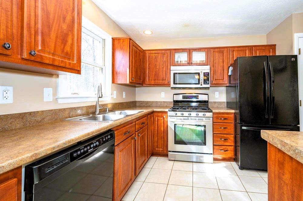 24 Lynmar Road Pittsburgh, PA 15209 - Photo 12 of 39 a kitchen with stainless steel appliances granite countertop a stove a sink and a refrigerator