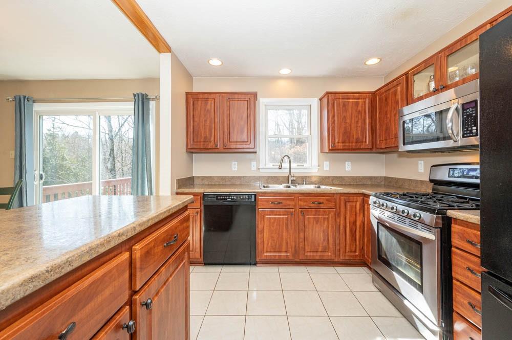 24 Lynmar Road Pittsburgh, PA 15209 - Photo 15 of 39 a large kitchen with stainless steel appliances granite countertop a stove a sink and a microwave