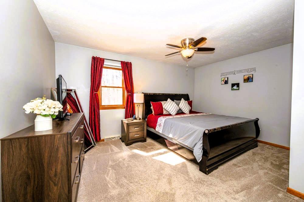 24 Lynmar Road Pittsburgh, PA 15209 - Photo 16 of 39 a bedroom with a bed and a chandelier