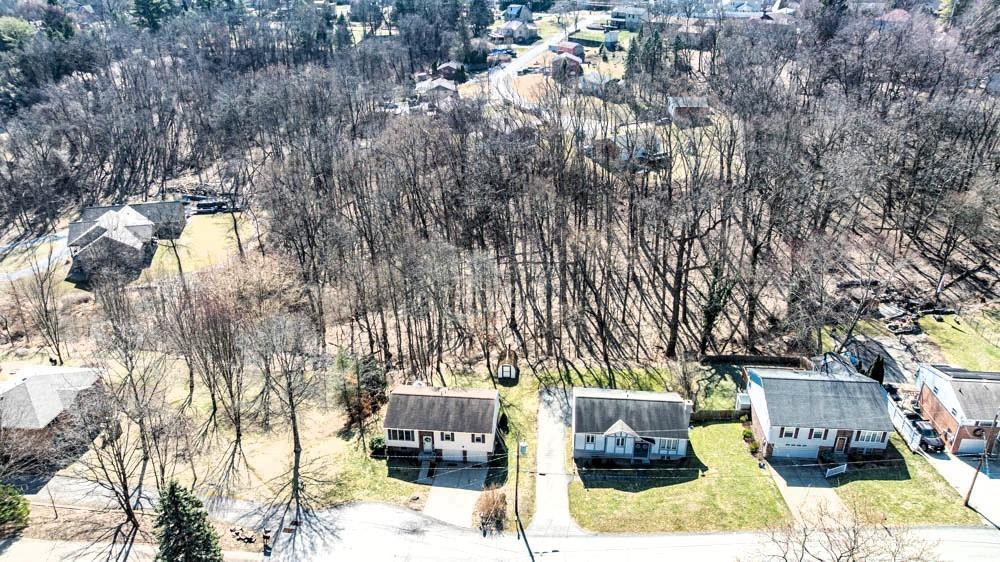 24 Lynmar Road Pittsburgh, PA 15209 - Photo 36 of 39 a view of backyard with a table and chairs couches under an umbrella