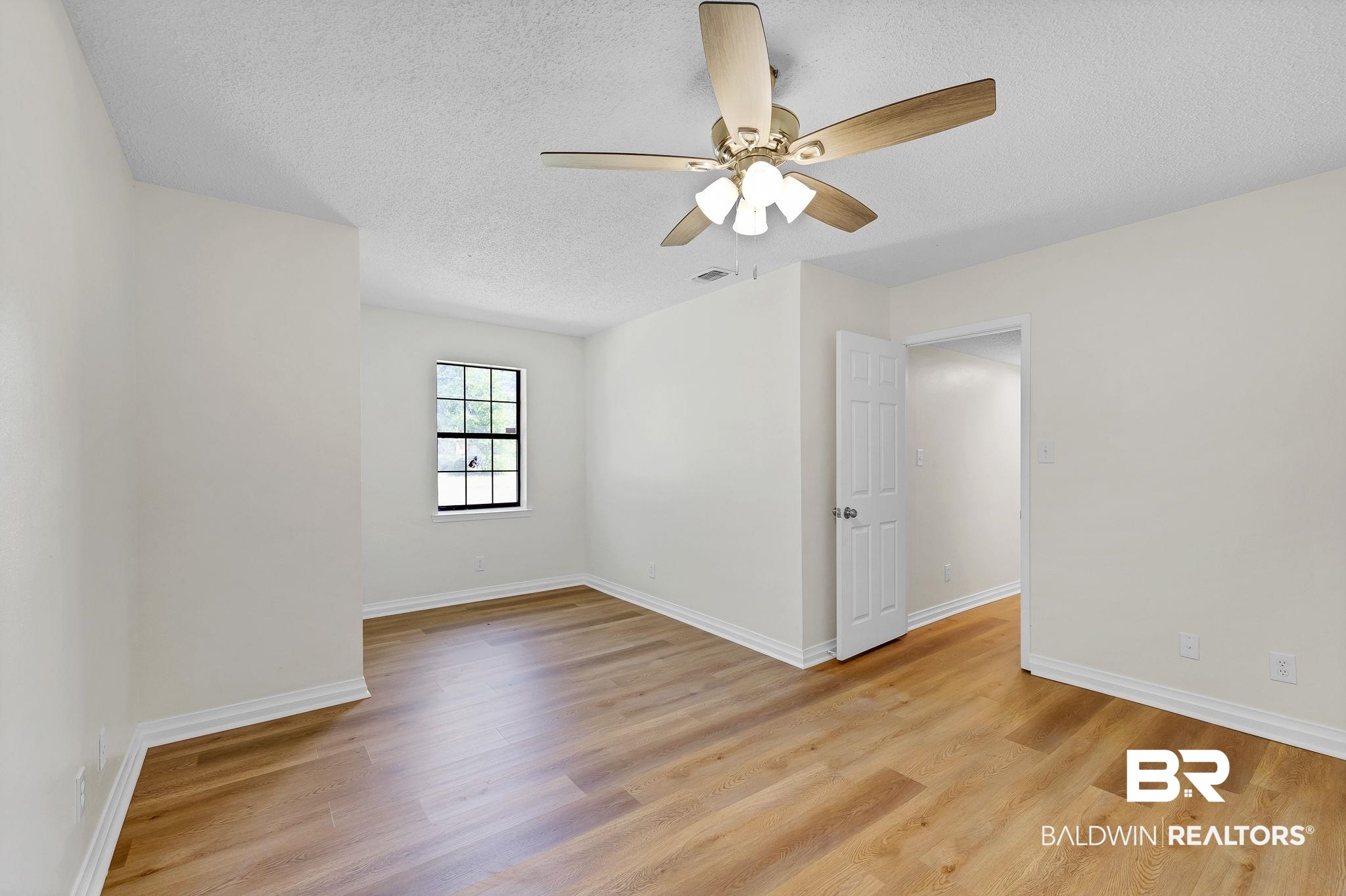 11964 Stroh Road Daphne, AL 36527 - Photo 27 of 58 Spare room with baseboards, light wood finished floors, a textured ceiling, and a ceiling fan