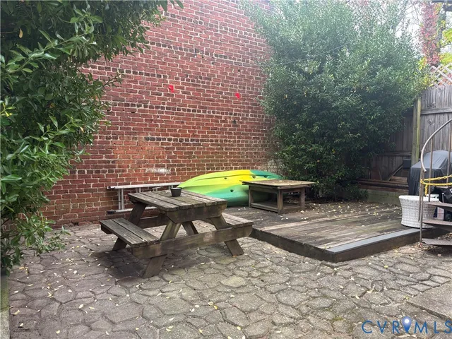 a view of a patio with a table and chairs