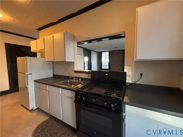 a kitchen with stainless steel appliances granite countertop a stove and a refrigerator