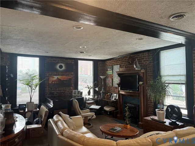 a living room with fireplace furniture and a fireplace