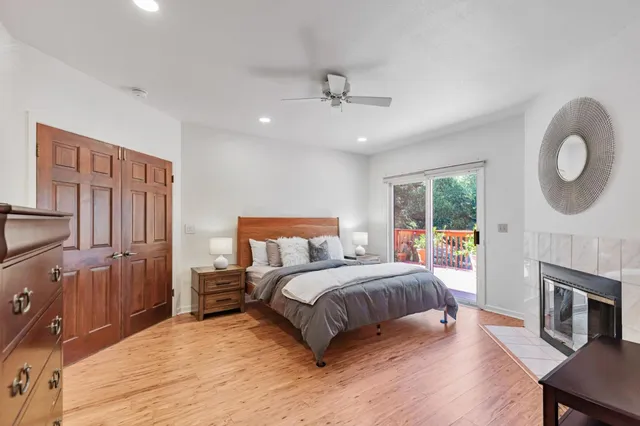 a bedroom with a large bed a flat tv screen and dresser