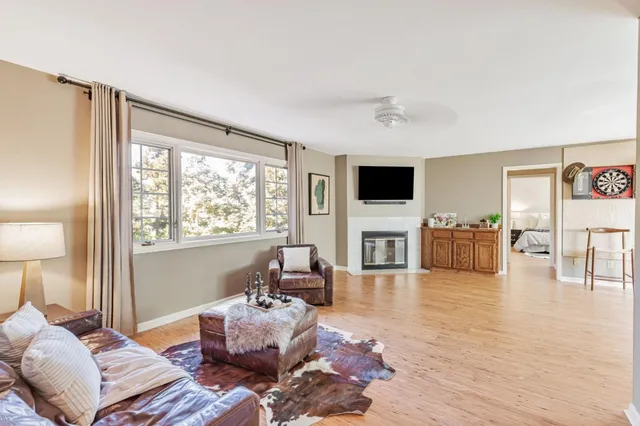 a living room with furniture fireplace and flat screen tv