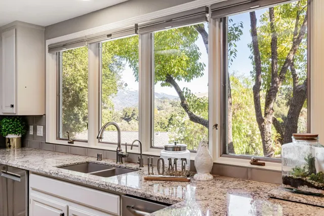 a kitchen with sink and large window