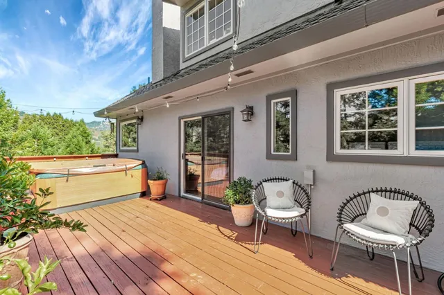 a front view of a house with barbeque oven and furniture