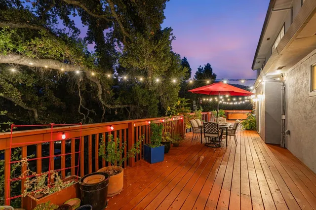 an outdoor sitting area with furniture and wooden floor