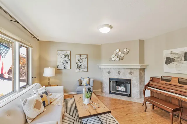 a living room with furniture fireplace and window
