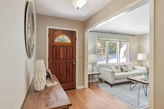 a living room with furniture a rug and a window