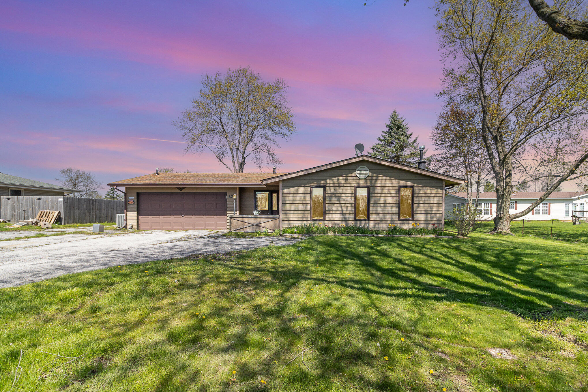 a front view of a house with a garden
