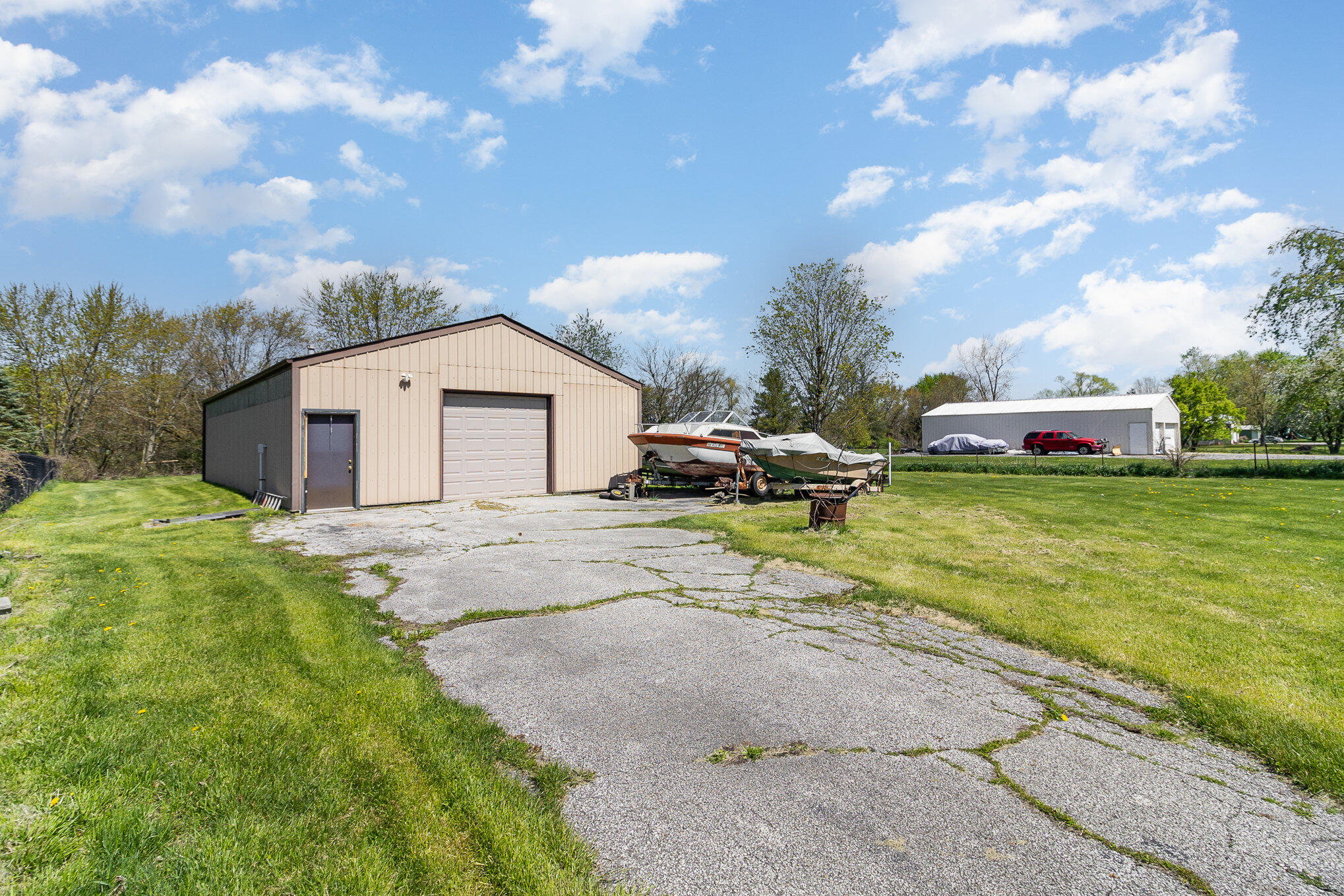 274 Highway 2 Hebron, IN 46341 - Photo 15 of 18 a view of a white house with a big yard and large trees