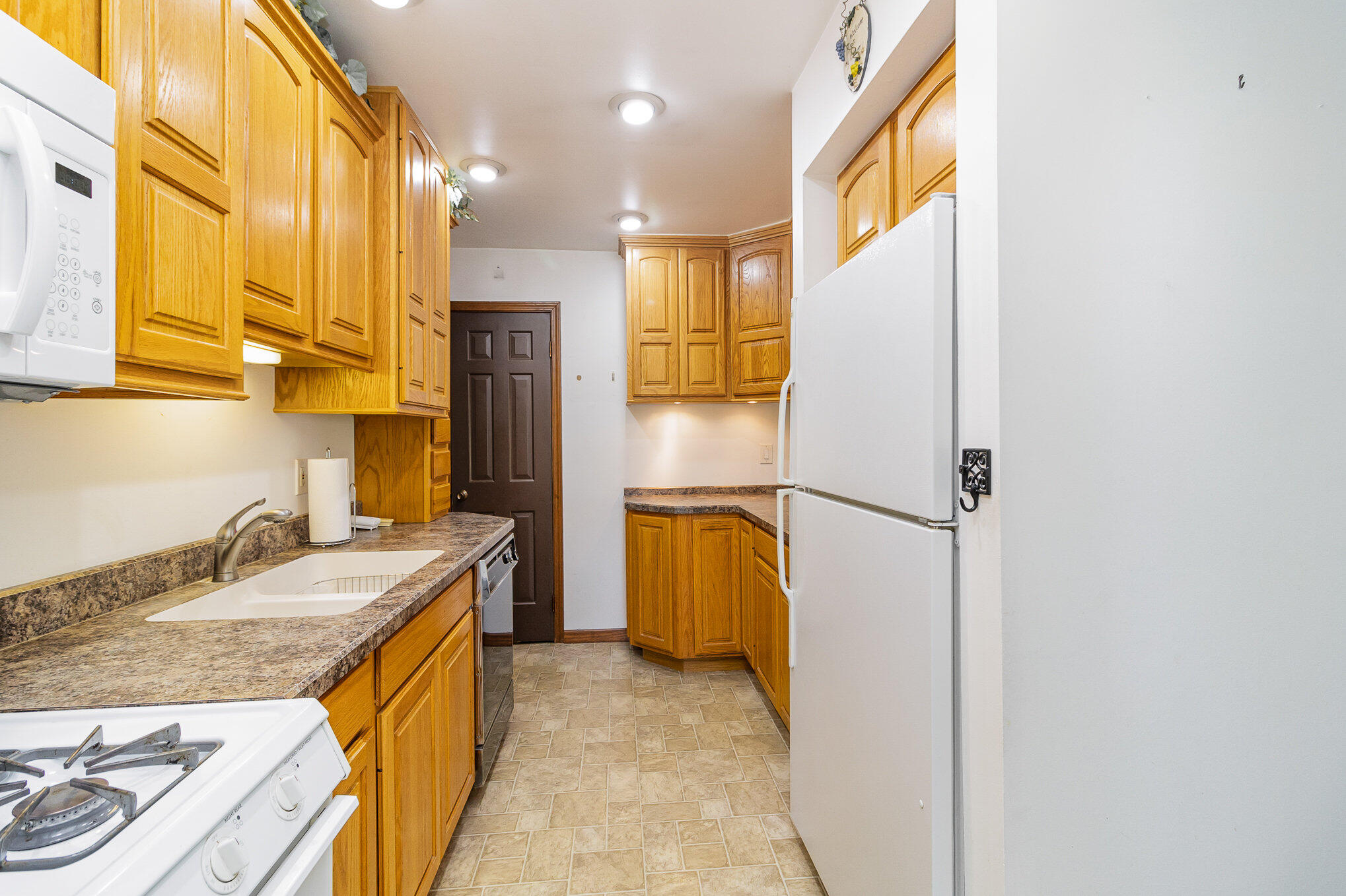 274 Highway 2 Hebron, IN 46341 - Photo 4 of 18 a bathroom with a granite countertop sink and a refrigerator