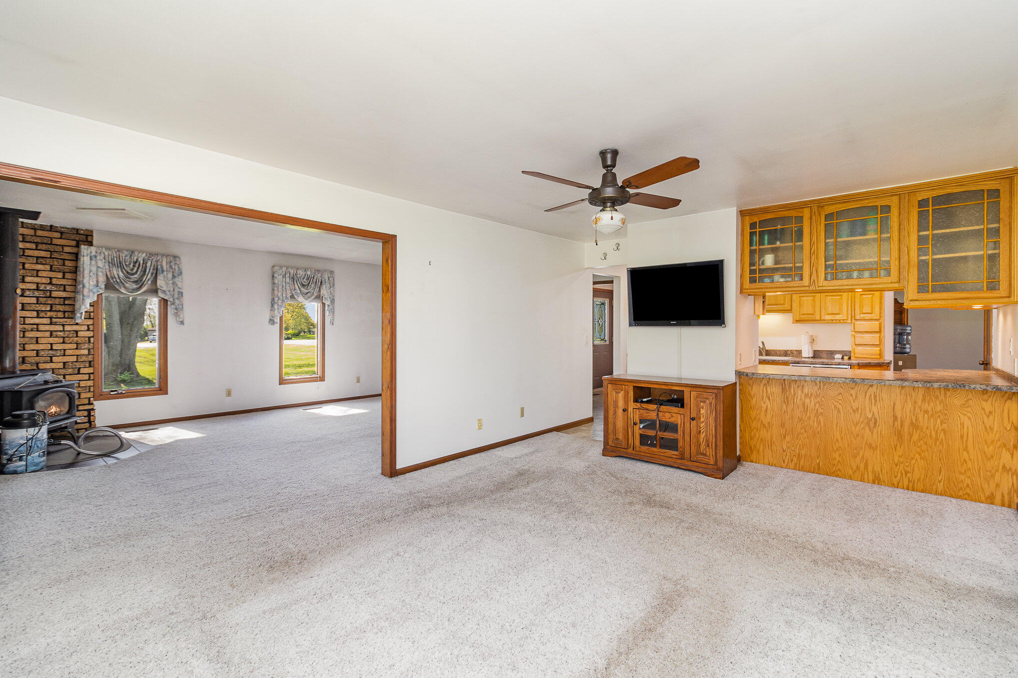 274 Highway 2 Hebron, IN 46341 - Photo 5 of 18 an empty room with a flat screen tv and a fireplace
