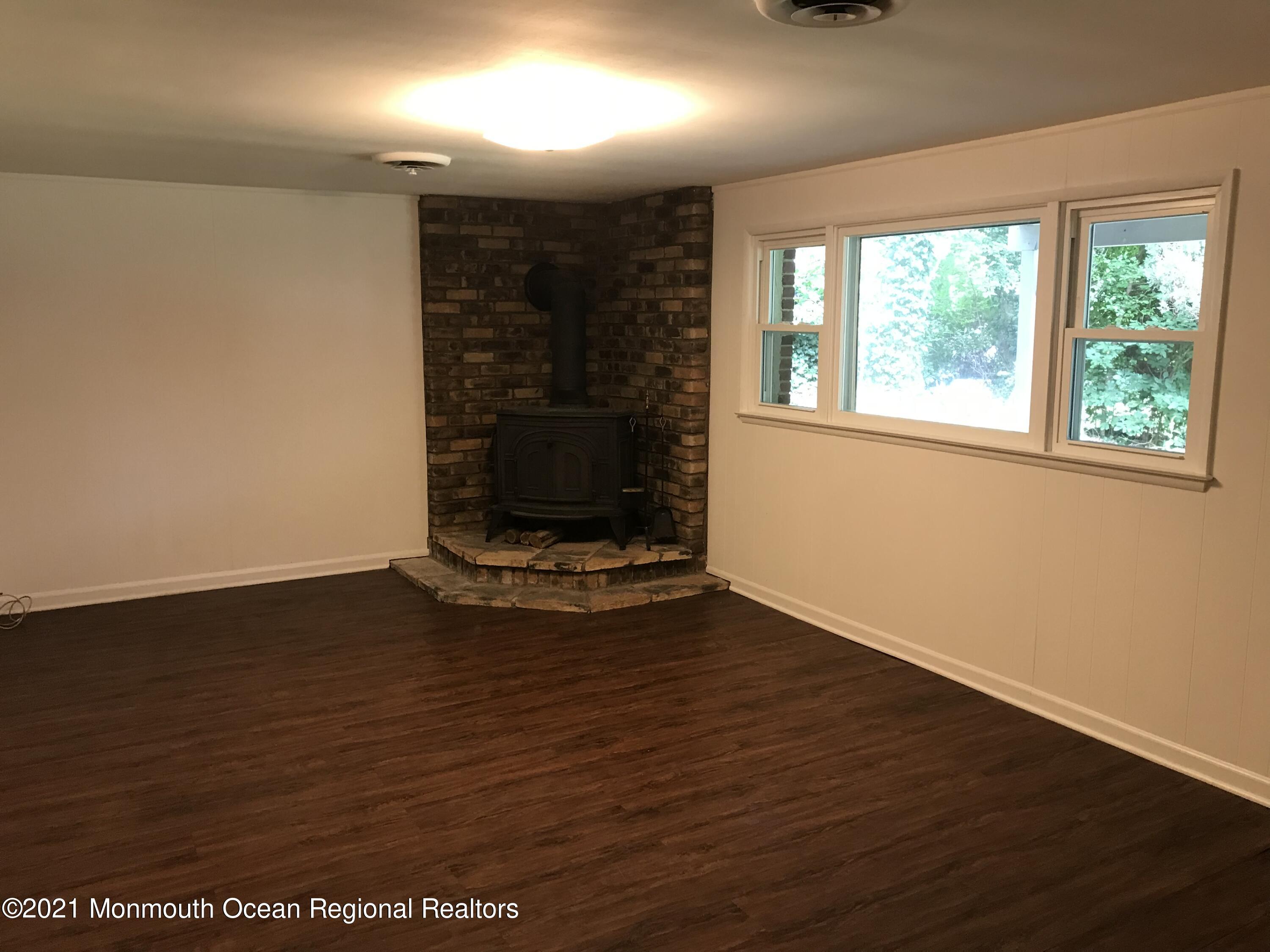 29 Prospect Road Atlantic Highlands, NJ 07716 - Photo 14 of 29 an empty room with wooden floor and windows
