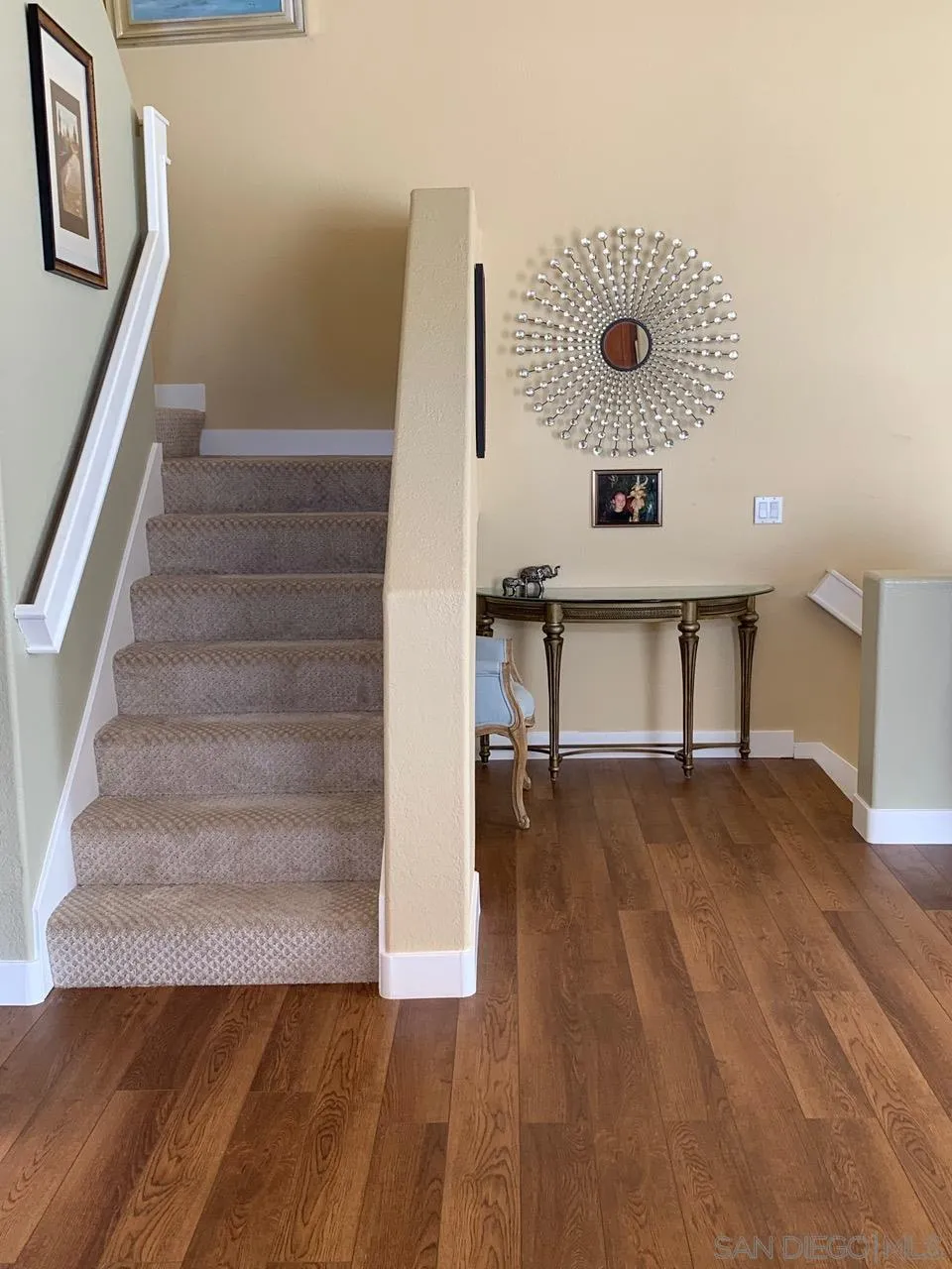 12602 Springbrook Drive, Unit B San Diego, CA 92128 - Photo 12 of 27 a view of an empty room with stairs and a wooden floor