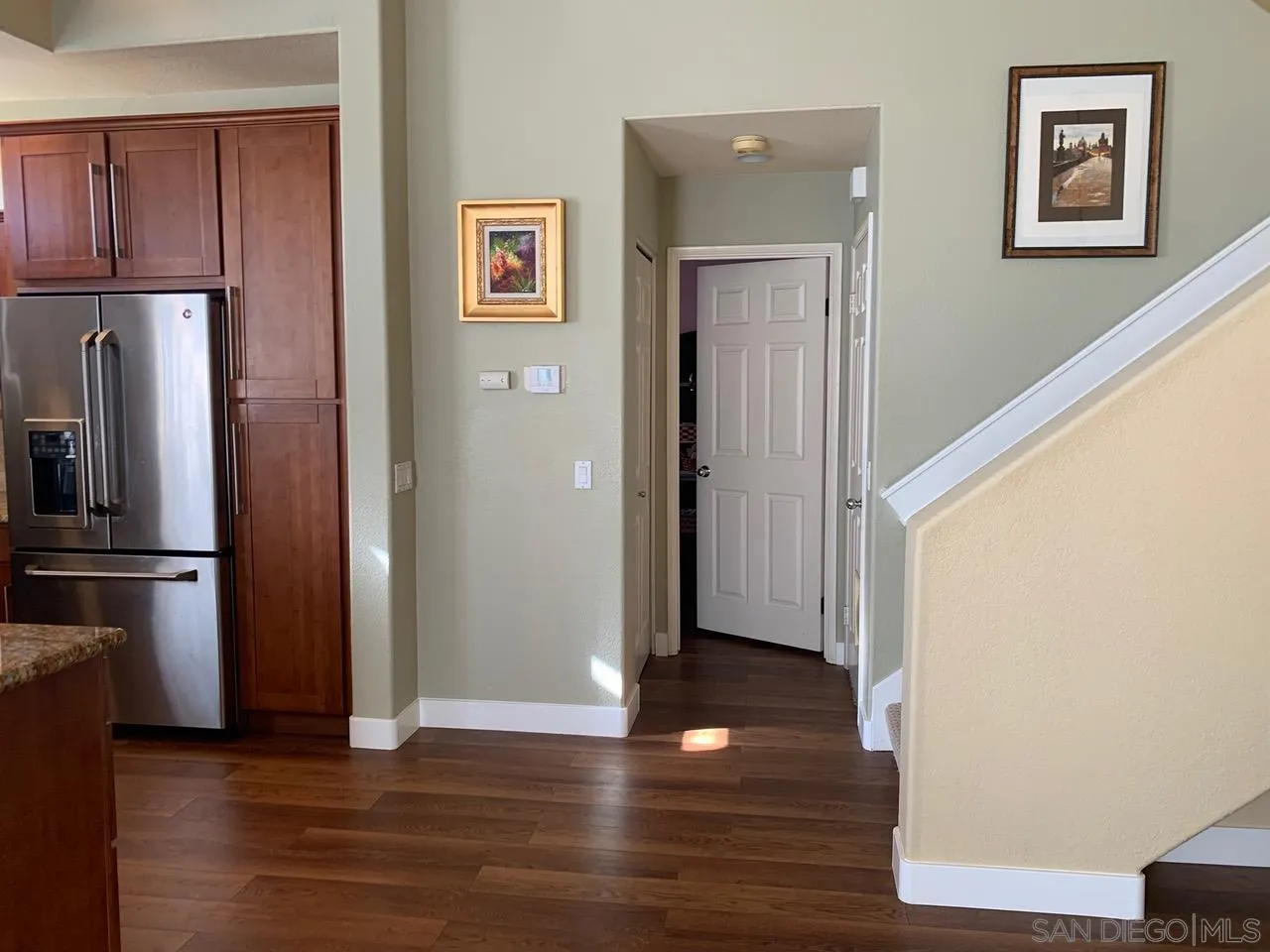12602 Springbrook Drive, Unit B San Diego, CA 92128 - Photo 14 of 27 a view of a kitchen with wooden floor and electronic appliances