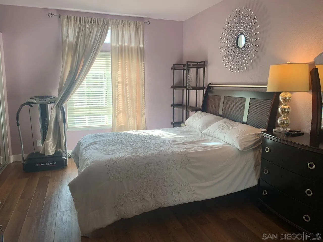 12602 Springbrook Drive, Unit B San Diego, CA 92128 - Photo 16 of 27 a bedroom with a bed and wooden floor