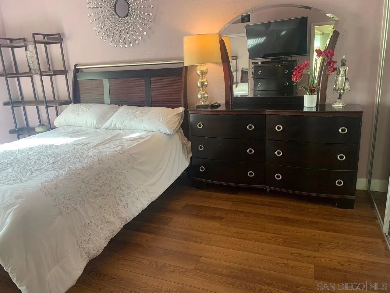 12602 Springbrook Drive, Unit B San Diego, CA 92128 - Photo 21 of 27 a bedroom with a bed and a mirror on dresser