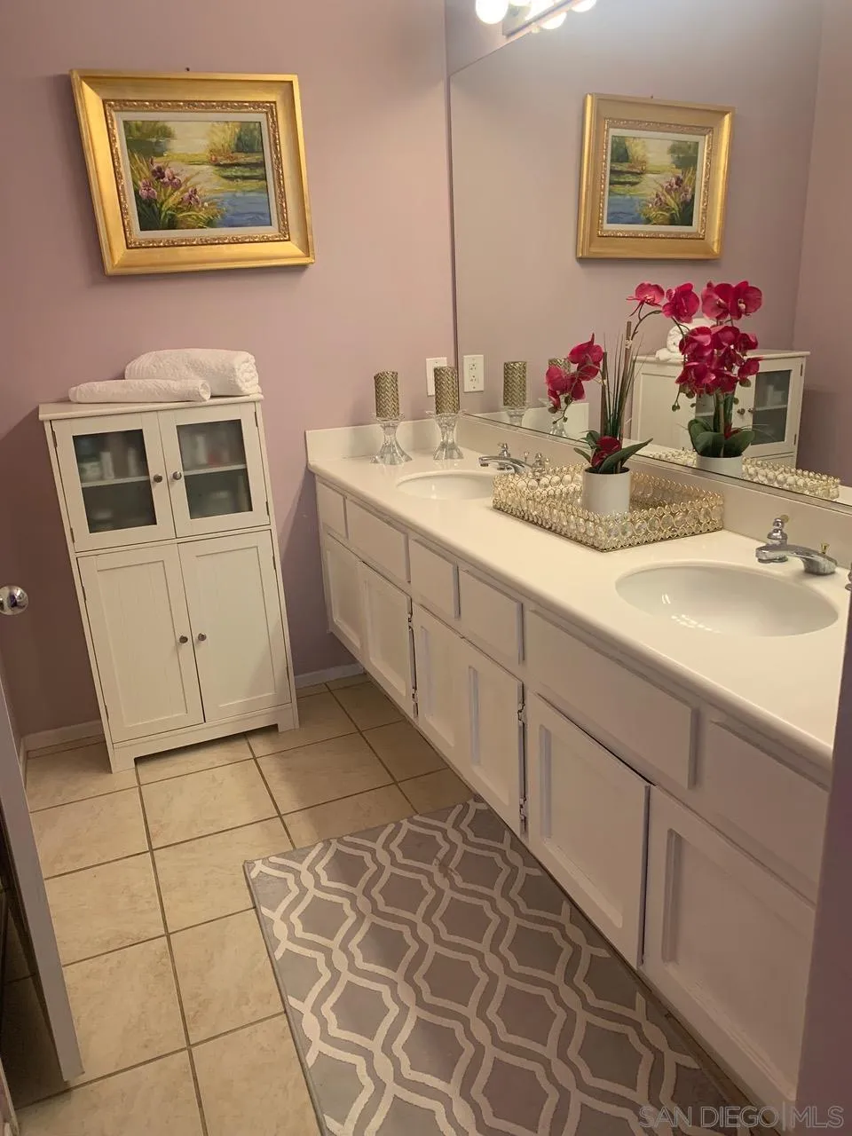 12602 Springbrook Drive, Unit B San Diego, CA 92128 - Photo 22 of 27 a bathroom with a sink mirror and vanity