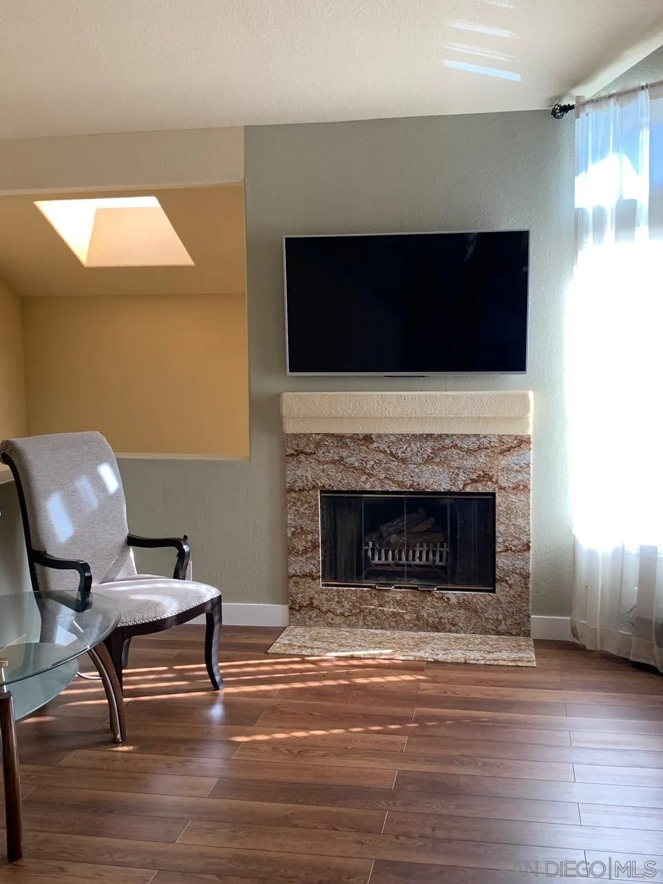 12602 Springbrook Drive, Unit B San Diego, CA 92128 - Photo 8 of 27 a living room with furniture and a fireplace