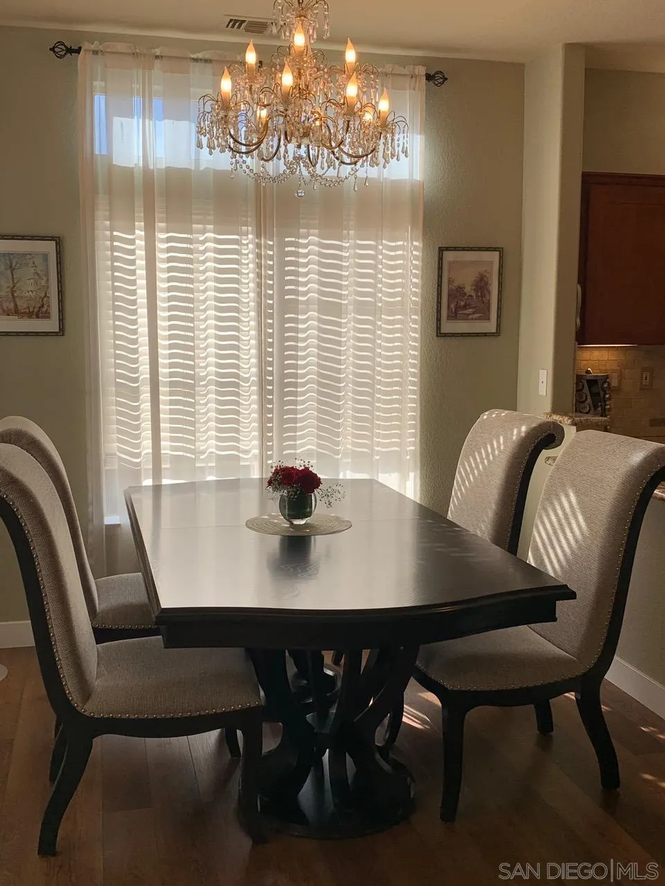 12602 Springbrook Drive, Unit B San Diego, CA 92128 - Photo 9 of 27 a view of a dining room with furniture and chandelier