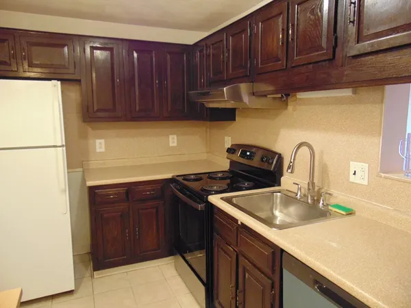 a kitchen with a refrigerator and a sink