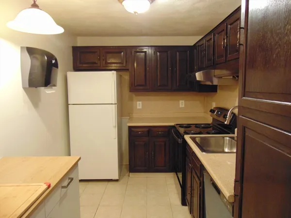 a kitchen with a sink cabinets and appliances