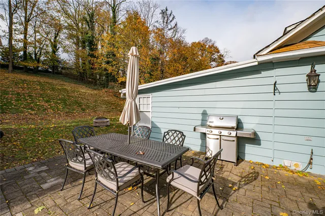 a backyard of a house with table and chairs