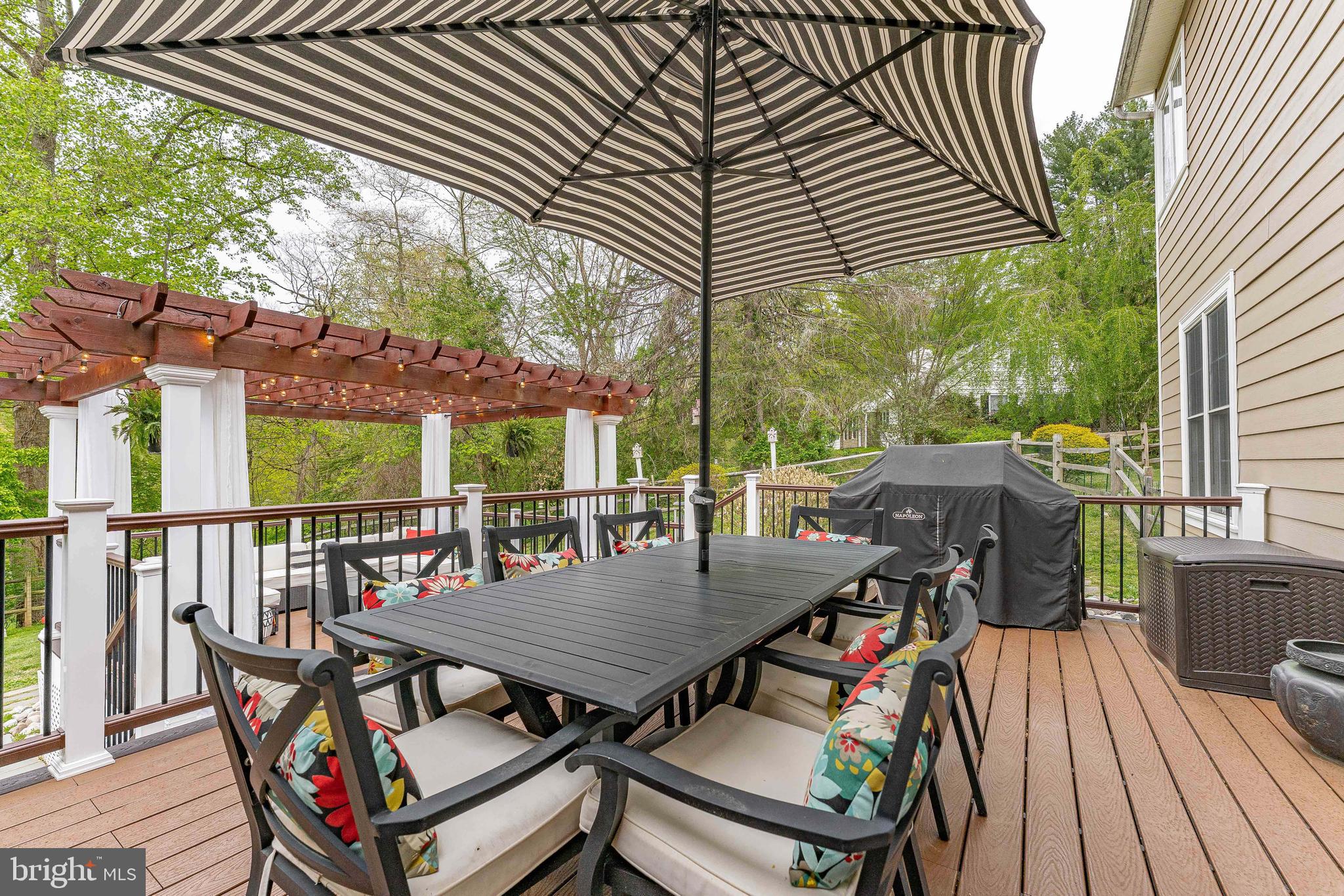 258 New Darlington Road Media, PA 19063 - Photo 111 of 120 a view of a patio with table and chairs under an umbrella with wooden floor