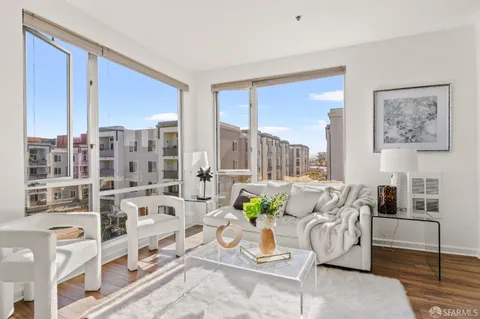 a living room with furniture and a floor to ceiling window